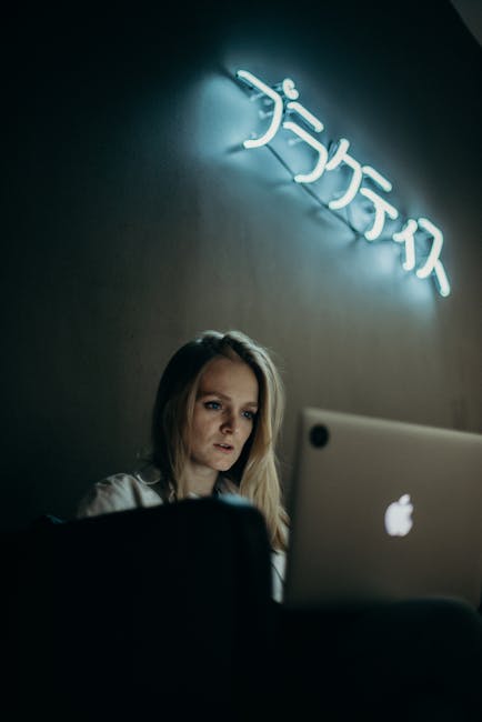 tired woman rubbing eyes while working at computer screen showing digital eye strain