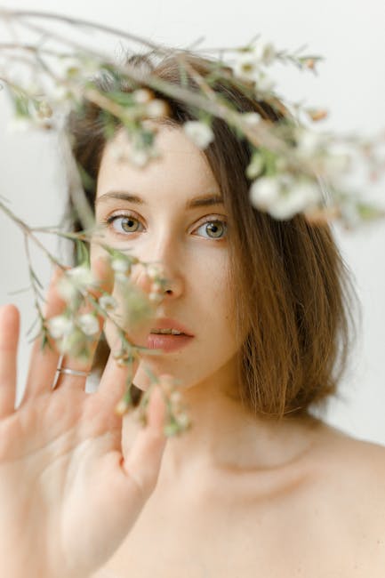 young woman performing gentle eye massage with fingers around eyes in peaceful setting